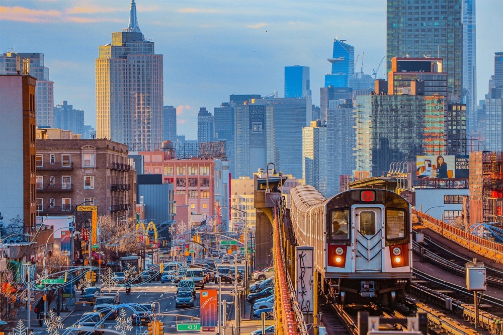 7 Line Subway Train in Queens with the Manhattan Skyline.